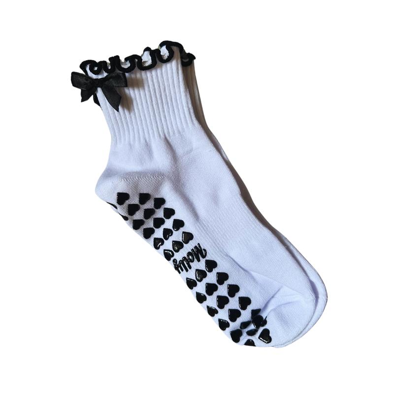 Black and white grip sock with bow and heart grips for pilates, barre, yoga or lagree